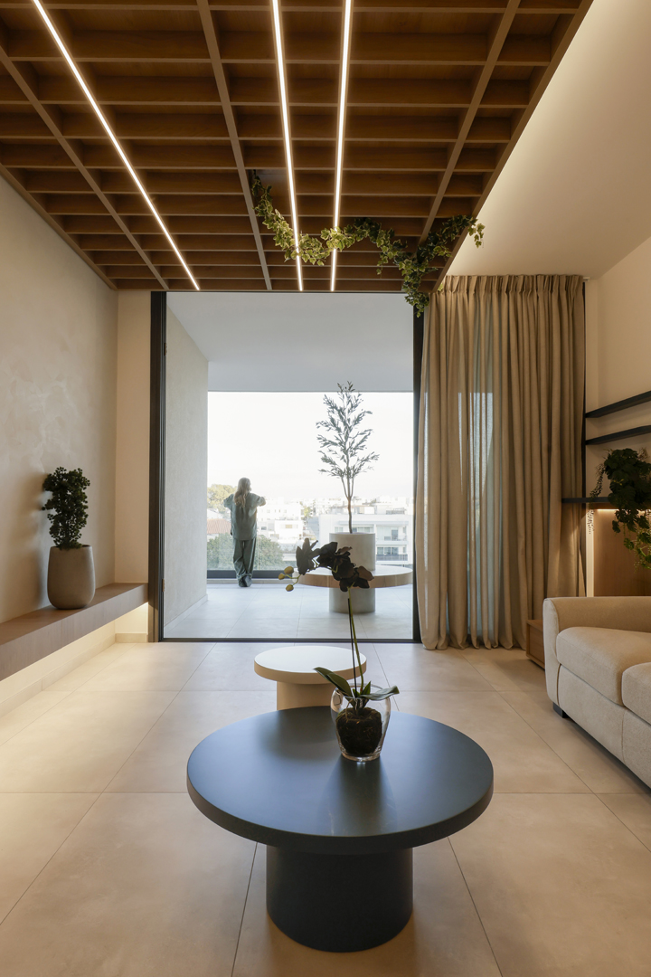 Psychologist office waiting area in Cyprus by KK Interior Design opening to terrace with wood ceiling grid and integrated lighting