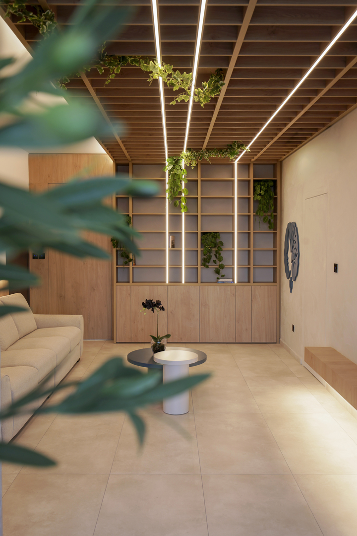 Terrace seating area connected to psychologist office by KK Interior Design with circular bench, planter, and view back into interior space